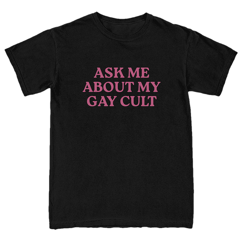A black short-sleeve crewneck t-shirt with the phrase 'ASK ME ABOUT MY GAY CULT' printed in pink serif capital letters across the chest.