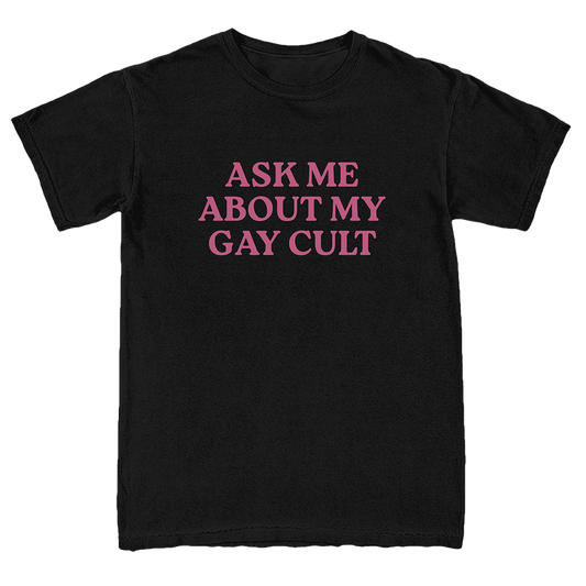 A black short-sleeve crewneck t-shirt with the phrase 'ASK ME ABOUT MY GAY CULT' printed in pink serif capital letters across the chest.